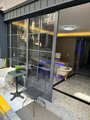 a patio with a table and chairs in front of a building at Robin Hotel in Istanbul