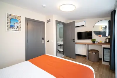 a bedroom with an orange bed and a desk at Robin Hotel in Istanbul