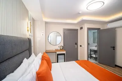 a bedroom with a bed and a sink and a mirror at Robin Hotel in Istanbul