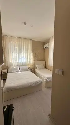 a bedroom with two beds and a window at Rota Star Hotel Beyoğlu in Istanbul
