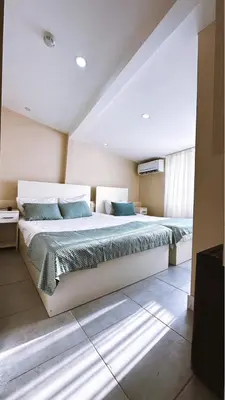 a bedroom with a large bed with blue pillows at Rota Star Hotel Beyoğlu in Istanbul