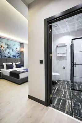 a bedroom with a bed and a bathroom with a tub at Comfort Point Two Hotel in Istanbul