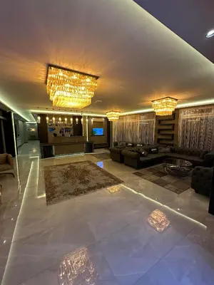 a living room with a couch and chandeliers at Comfort Point Two Hotel in Istanbul