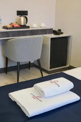 a table with two white towels on top of it at Comfort Point Two Hotel in Istanbul