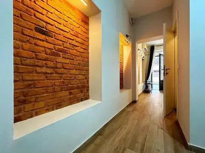 a hallway with a brick wall and a brick hallway at Triplex in Taksim Square with 4 Bedroom in Istanbul