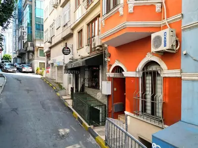 an orange building on the side of a street at Triplex in Taksim Square with 4 Bedroom in Istanbul