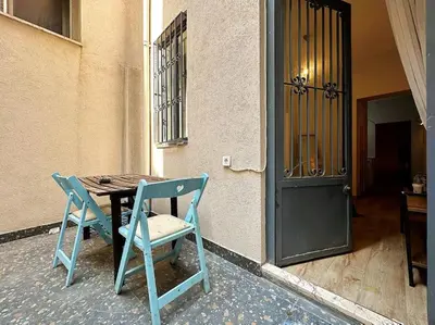 a table and two chairs sitting next to a door at Triplex in Taksim Square with 4 Bedroom in Istanbul