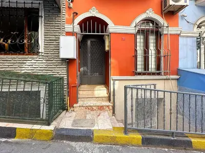 an orange building with a door and a gate at Triplex in Taksim Square with 4 Bedroom in Istanbul