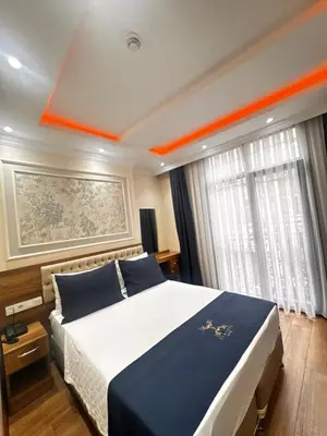 a bedroom with a large bed with an orange line on the ceiling at New Fors Hotel in Istanbul