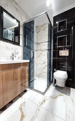 a bathroom with a glass shower and a toilet at New Fors Hotel in Istanbul