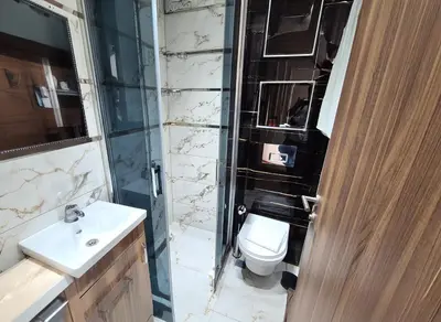 a bathroom with a toilet and a glass shower at New Fors Hotel in Istanbul