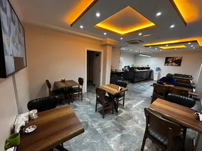 a dining room with wooden tables and chairs at New Fors Hotel in Istanbul