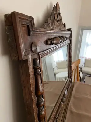 an old mirror with a wooden frame on a table at Konak Maksem in Bursa