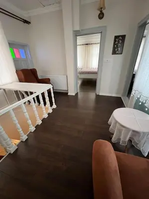 a living room with a staircase and a table at Konak Maksem in Bursa