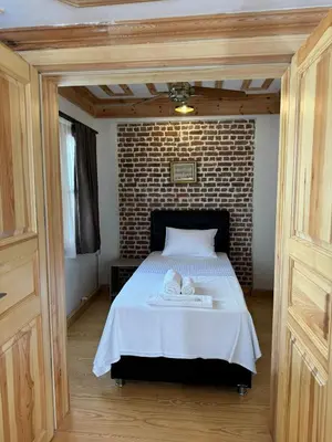 a bedroom with a bed with a brick wall at HanFlats in Istanbul