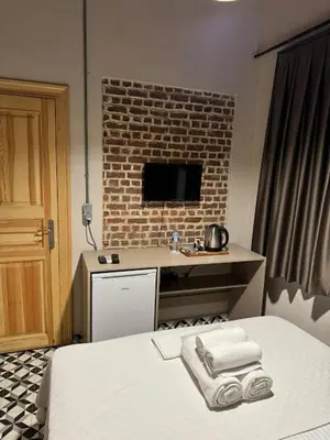 a bedroom with a bed and a desk with towels at HanFlats in Istanbul