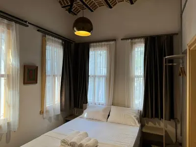 a bedroom with a bed in front of windows at HanFlats in Istanbul