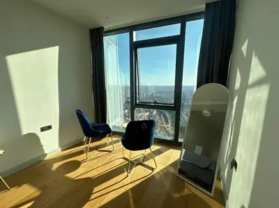 a room with two chairs and a table and a large window at Modern Luxury apt at Sinpas Queen in Istanbul