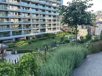 a large apartment building with a park in front of it at Modern Luxury apt at Sinpas Queen in Istanbul