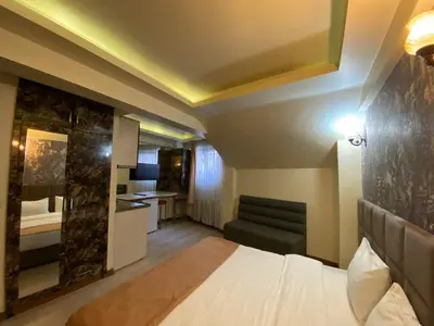 a hotel room with a bed and a kitchen at taksim terra suit 2 in Istanbul