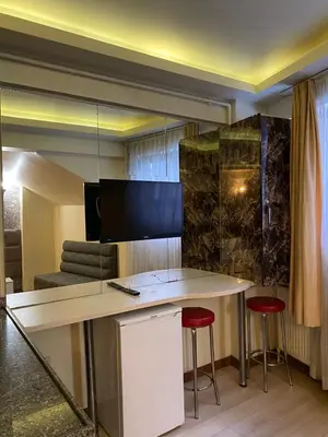 a room with a desk with two red stools at taksim terra suit 2 in Istanbul