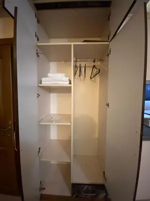 a walk in closet with white doors and shelves at taksim terra suit 2 in Istanbul