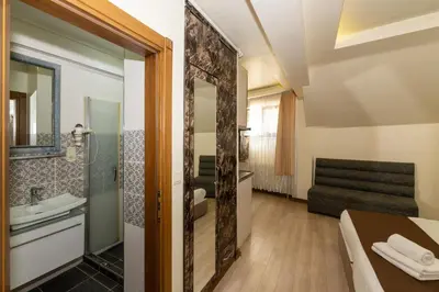 a bathroom with a tub and a sink and a mirror at taksim terra suit 2 in Istanbul