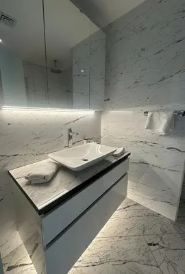 a white bathroom with a sink and a mirror at Sinpaş Queen Bomonti Residence by Bondy in Istanbul