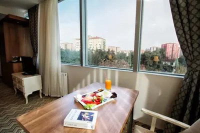a room with a table with a bowl of fruit on it at Sarissa Hotel in Istanbul