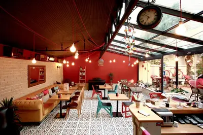 a restaurant with tables and chairs and a clock on the wall at Ottoman Suites by Sera House in Istanbul