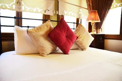 a bedroom with a bed with four pillows on it at Ottoman Suites by Sera House in Istanbul
