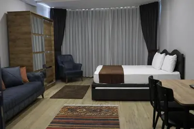 a hotel room with a bed and a couch and a table at Tavra Daltaban in Istanbul