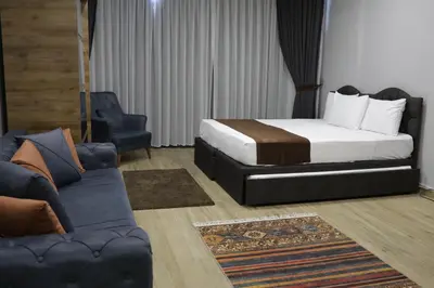 a hotel room with a bed and a couch at Tavra Daltaban in Istanbul
