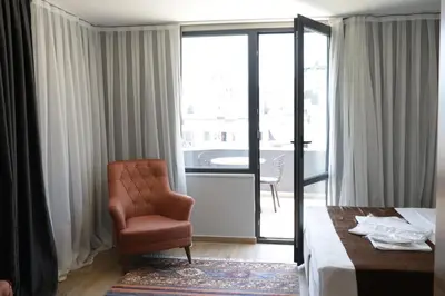 a room with a bed and a chair and a window at Tavra Daltaban in Istanbul