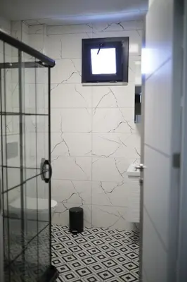 a bathroom with a tv hanging on the wall at Tavra Daltaban in Istanbul