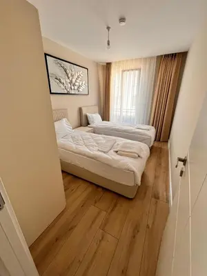 two beds in a room with wooden floors at Sense Suite Residence-15 in Istanbul