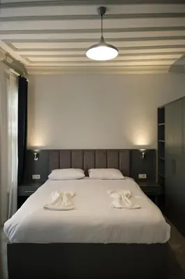 a bedroom with a large bed with two towels on it at Lighthouse in Istanbul