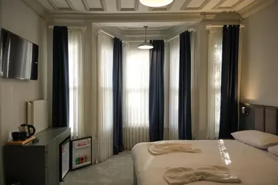 a bedroom with a bed and some windows at Lighthouse in Istanbul