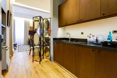 a kitchen with wooden cabinets and a counter top at Ravouna 1906 Bosphorus Istanbul in Istanbul