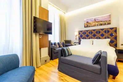 a hotel room with a bed and a couch at Ravouna 1906 Bosphorus Istanbul in Istanbul
