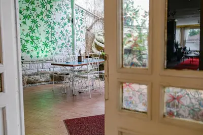 a door leading into a room with a table and chairs at Green Moringa Termal Hotel in Termal