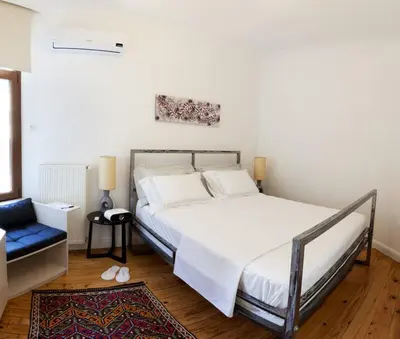 a bedroom with a bed and a blue chair at Bomonti Residence 3 bedroom duplex in Istanbul