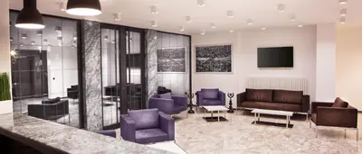 a lobby with couches and chairs and a television at Nish Suites Atasehir in Istanbul