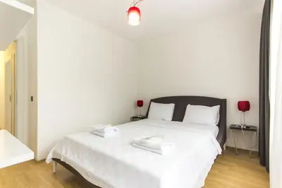 a bedroom with a white bed with two trays on it at Nish Suites Atasehir in Istanbul