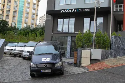 a car parked in a parking lot in front of a building at Nish Suites Atasehir in Istanbul