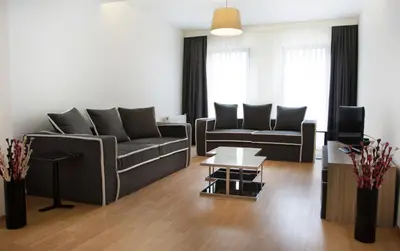 a living room with two couches and a tv at Nish Suites Atasehir in Istanbul