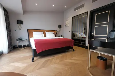 a bedroom with a bed with a red blanket and a piano at Nordstern Hotel Galata in Istanbul