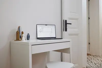 a laptop computer sitting on a white desk in a room at Charming 2BR AC in Center - Santur D1 in Istanbul