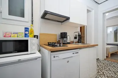 a small kitchen with a microwave and a counter at Charming 2BR AC in Center - Santur D1 in Istanbul