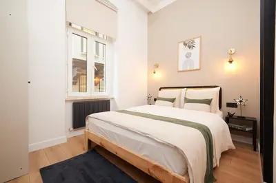 a white bedroom with a large bed and a window at Charming 3BR 2Bath AC in Center - Santur D2 in Istanbul